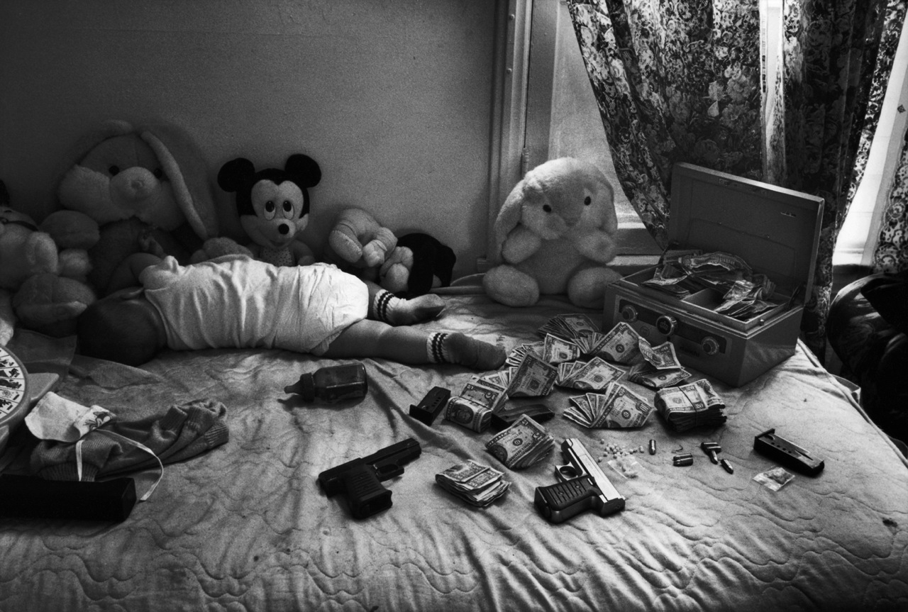 Robert Yager was a 2012 finalist for the Eugene Smith Grant for his project Loaded.
                              Money collected from crack-cocaine sales is counted next to a sleeping baby—roughly $3,000 in cash. The gang member in charge threw down some guns, bullets and rocks of crack-cocaine while the photographer went to retrieve his tripod.