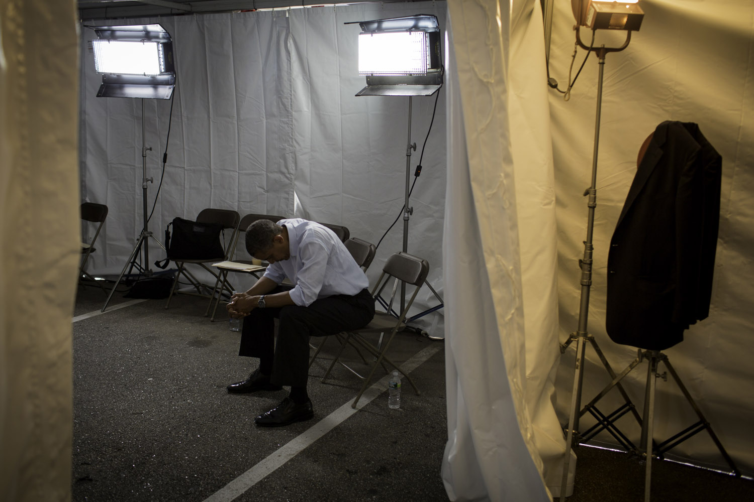 Image: After a long day, President Obama waits in a tent before a rally at the Rochester Commons in Rochester N.H. Aug. 18, 2012.