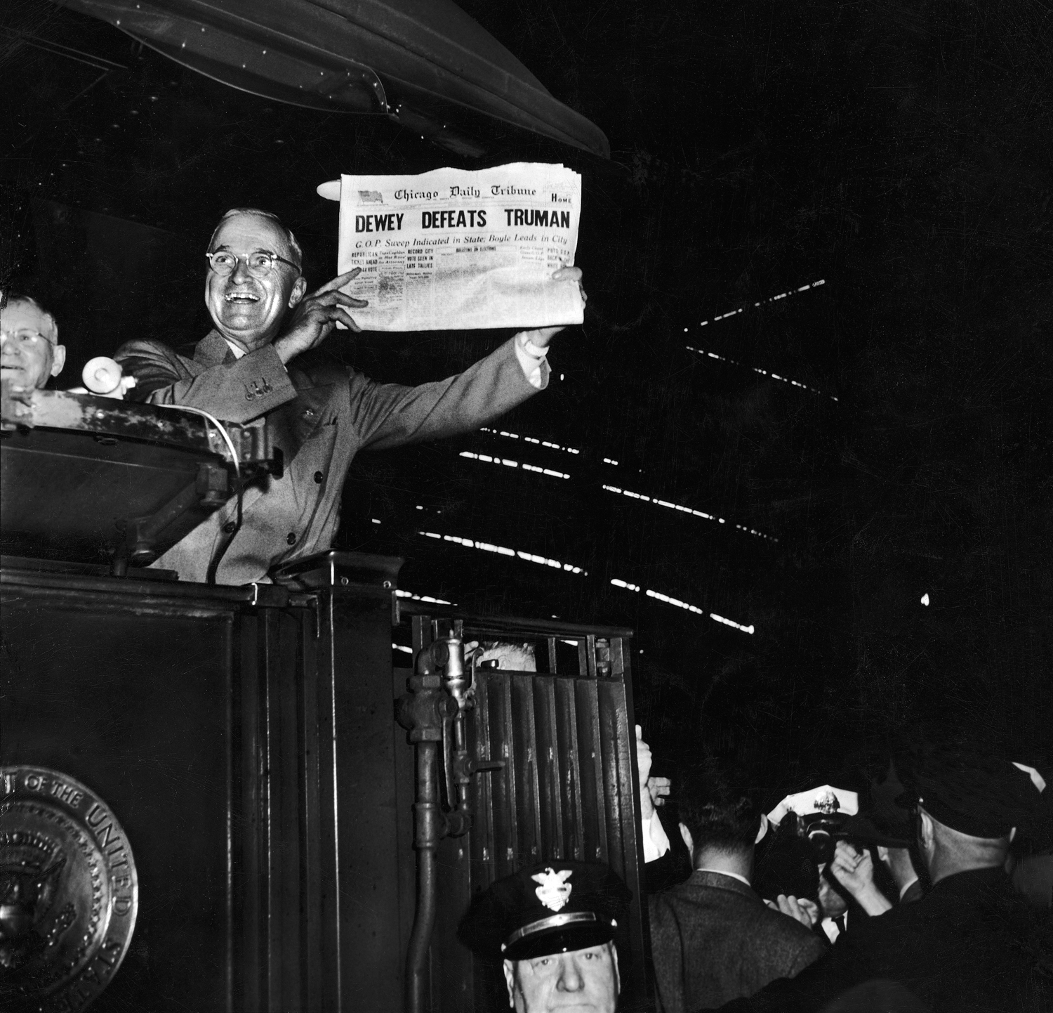 President Harry Truman jubilantly holds up a Chicago newspaper emblazoned with the (erroneous) headline, DEWEY DEFEATS TRUMAN. In fact, Truman handily beat New York governor Thomas Dewey in the tight 1948 presidential election.