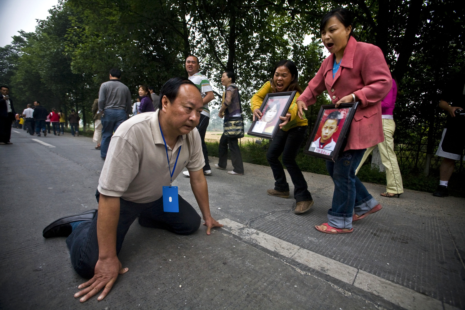 2006: Shiho Fukada
                              Jiang Guohua, the Communist Party secretary of Mianzhu city, kneels on the ground pleading with protesting parents, whose children were killed in a school collapse during China's recent devastating earthquake, not to complain to higher authorities, in Mianzhu, Sichuan province on May 25, 2008. Despite Jiang's pleas, the parents of the 127 children who died in the collapse kept marching Sunday and eventually met with higher officials, who told them the government would investigate.
                              
                               Advice—keep shooting. It was just so inspiring to be there with other talented participants and mentors that weekend. The passion and love that people have for photojournalism really lifted me up and made me believe in what we do.