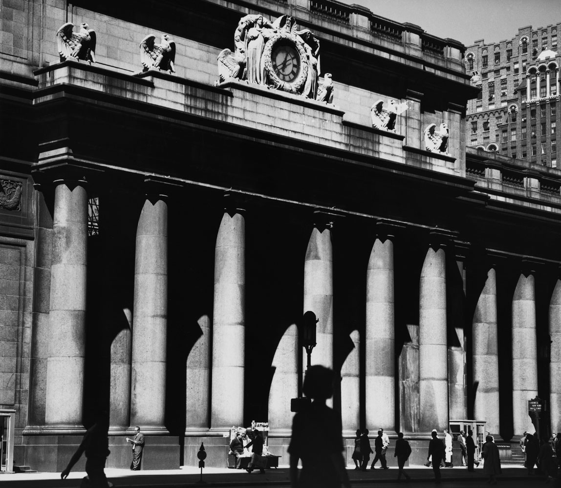 Graced by goddesses and stalwart eagles and crowned by a balustrade, Pennsylvania Station presents a serene and seemingly timeless facade to New York's Seventh Avenue, 1963.