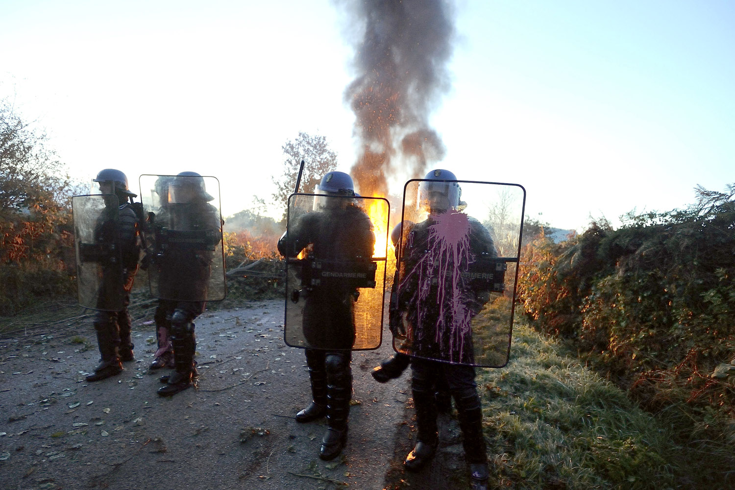 Image: Oct. 30, 2012. French gendarmes police stand guard during an evacuation of squatters who oppose a project to build an international airport in Notre-Dame-des-Landes, in western France.