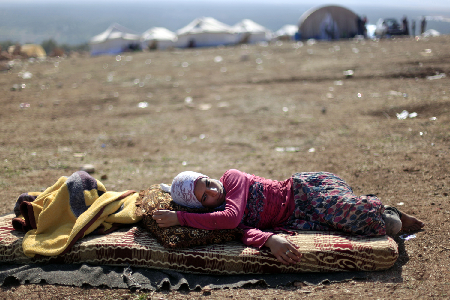 Image: Nov. 5, 2012. A Syrian girl who fled with her family from the violence in their village, rests at a displaced camp, in the Syrian village of Atma, near the Turkish border.