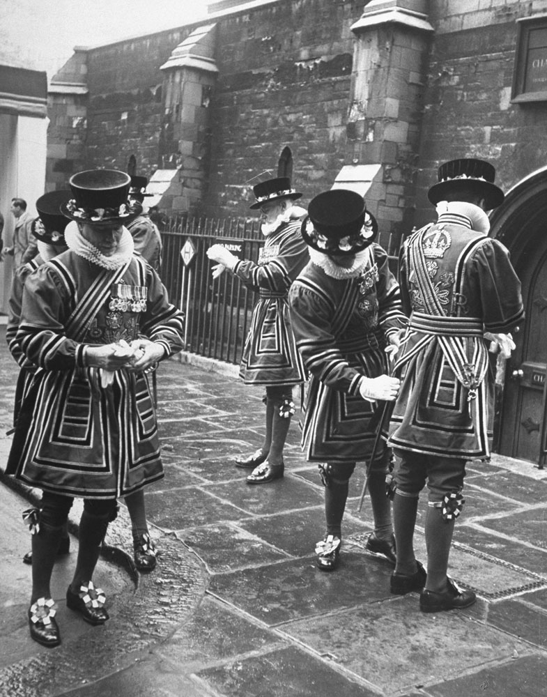 Caption from LIFE.  Beefeaters adjust their uniforms.