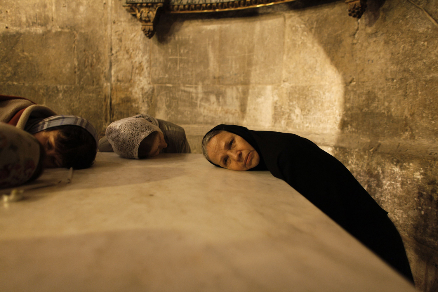 Image: Nov. 11, 2012. Christian worshippers pray in the Church of the Holy Sepulchre in Jerusalem's Old City.