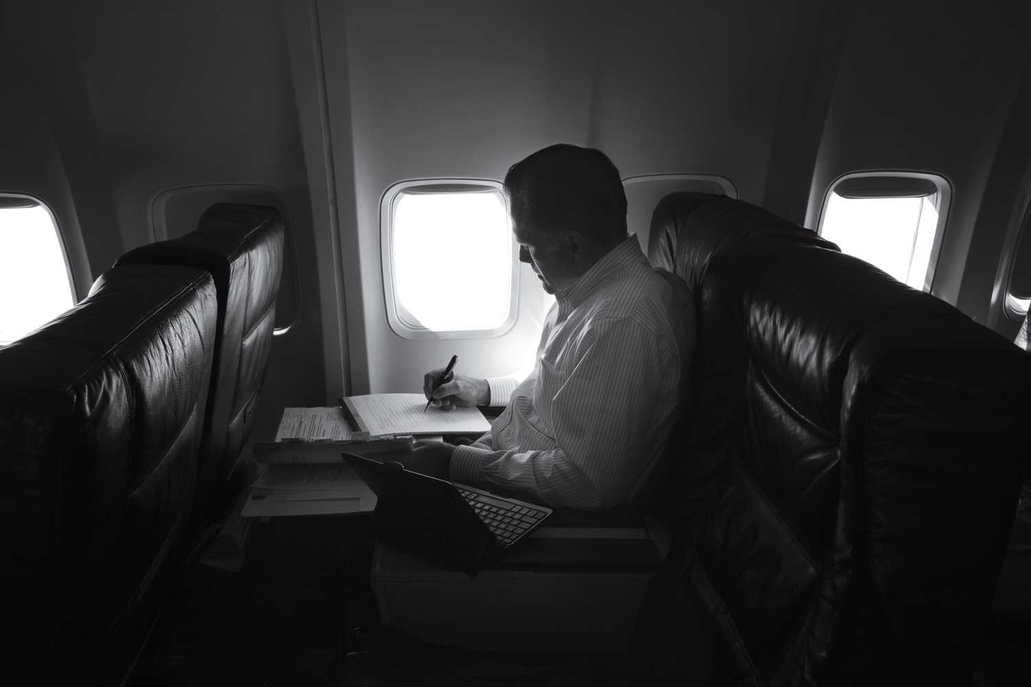 Image: Mitt Romney, in a quiet moment, works on the plane heading towards events in New Orleans. Aug. 20, 2012.