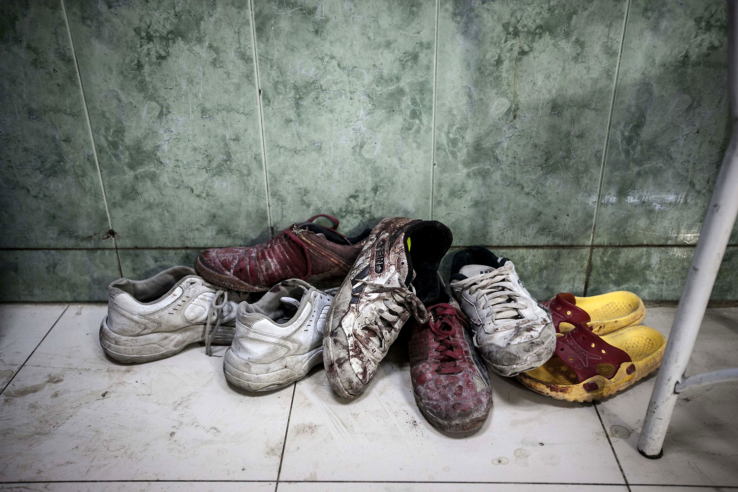 Image: Nov. 1, 2012. A pile of shoes covered by blood from wounded or dead residents lies at the entrance of the emergency ward at a hospital in the Tarik Al-Bab neighborhood in Aleppo, Syria.