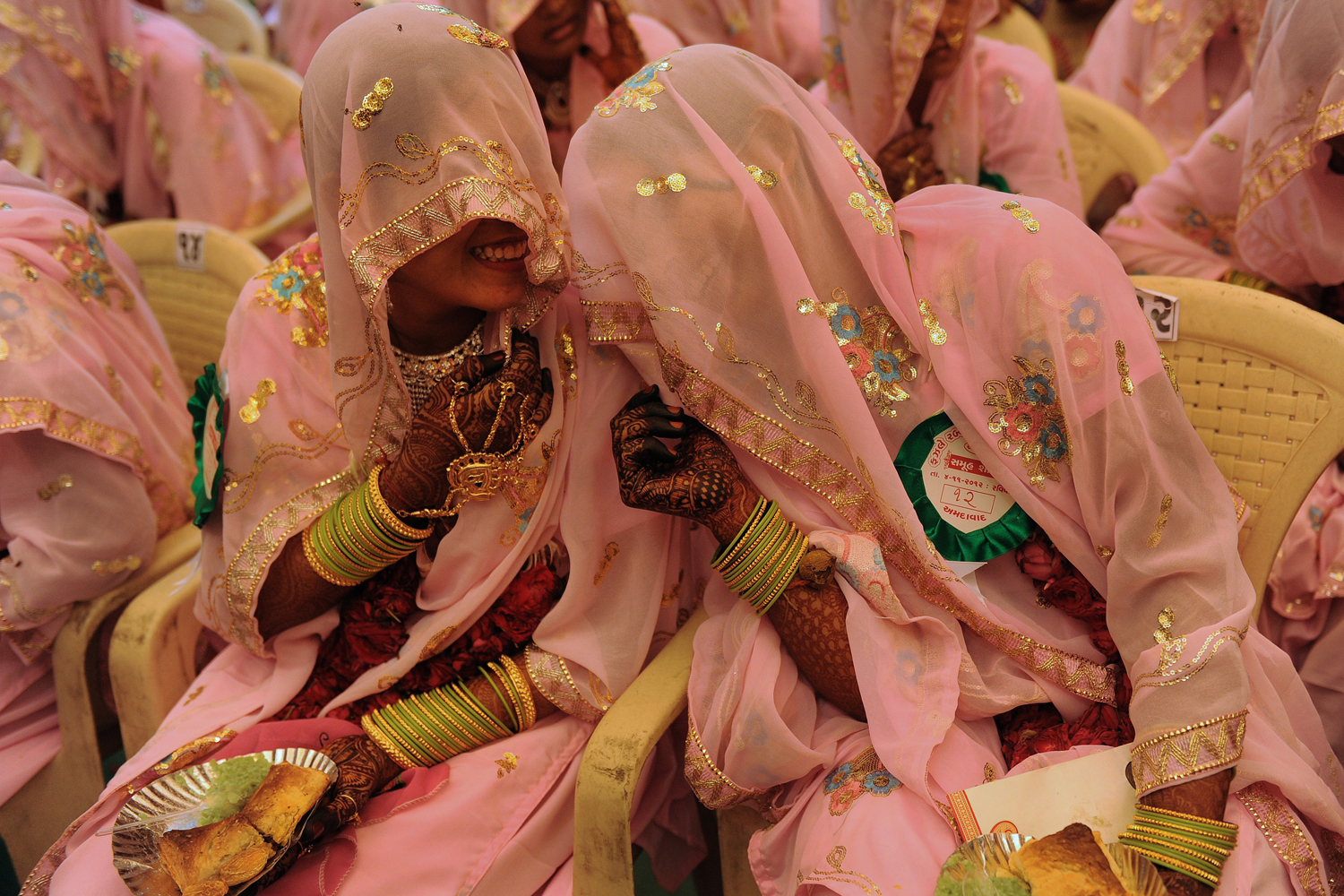 Image: Nov. 4, 2012. Indian Muslim brides chat as they wait for the start of a mass wedding ceremony in Ahmedabad.