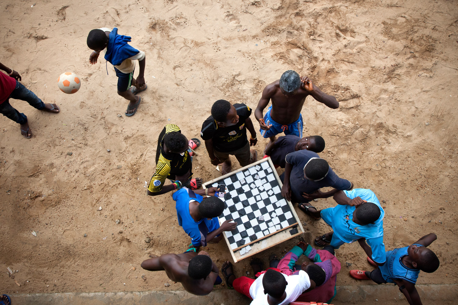Checkers is popular in Sierra Leone, and provides entertainment for groups of young people at the Saint Michael rehabilitation center.