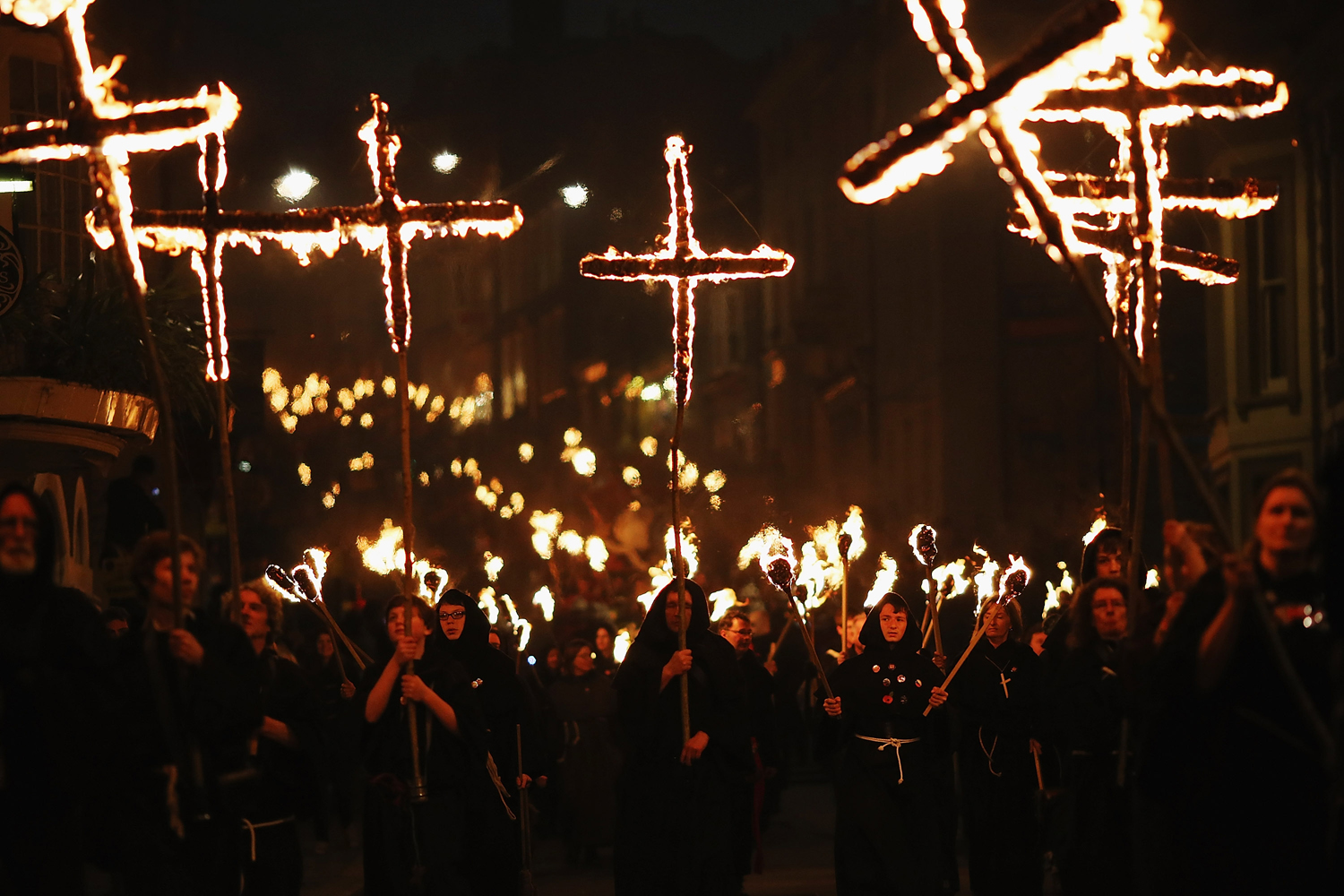 Image: Nov. 5, 2012. Revelers walk with burning crosses during the Bonfire Night celebrations in Lewes, Sussex in England. Bonfire Night is related to the ancient festival of Samhain, the Celtic New Year.