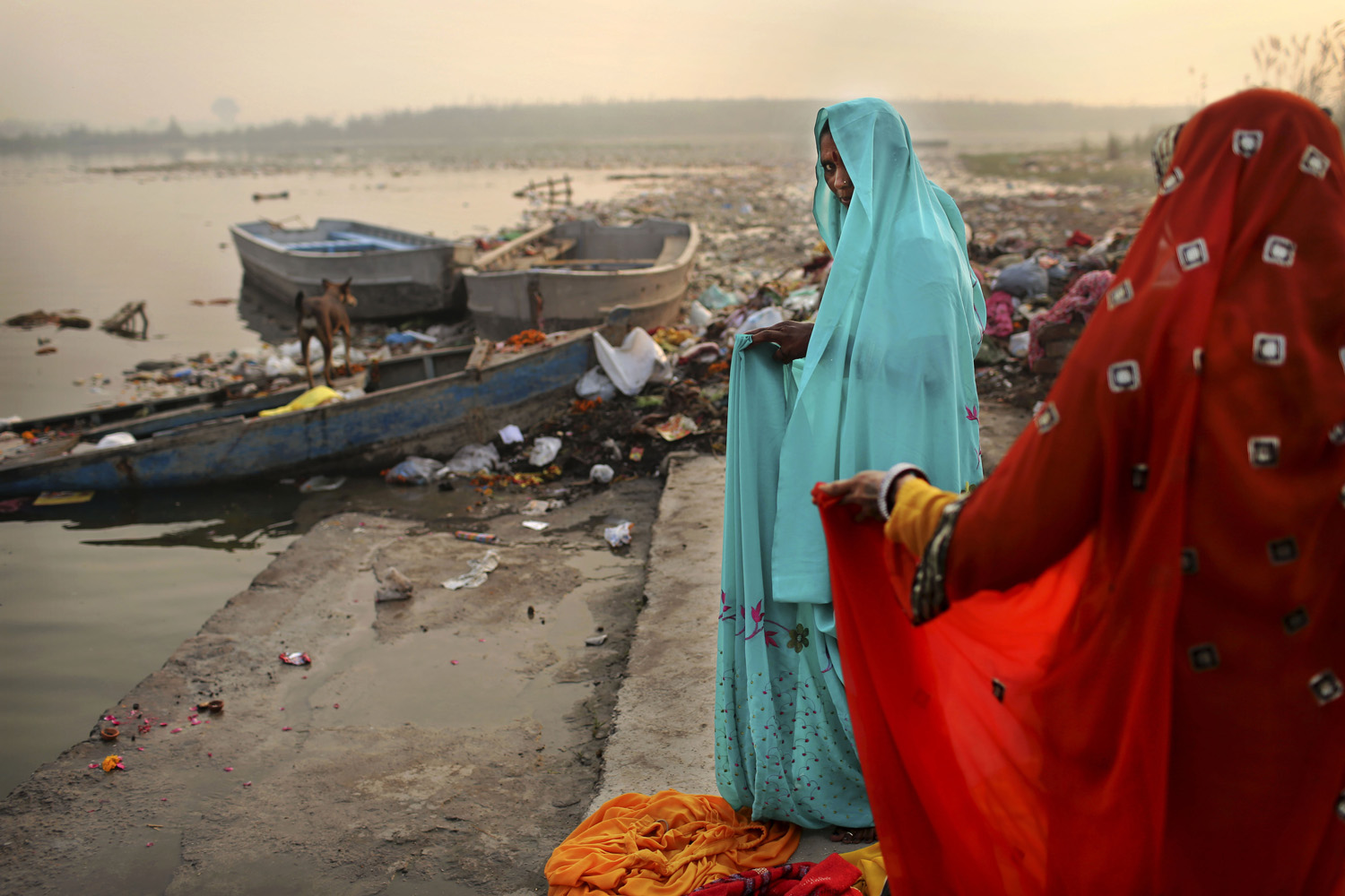 Image: Oct. 29, 2012. Hindu devotees put on saris after taking a holy dip in the Yamuna River on Sharad Purnima, an auspicious day for the new moon in the fall, in New Delhi.