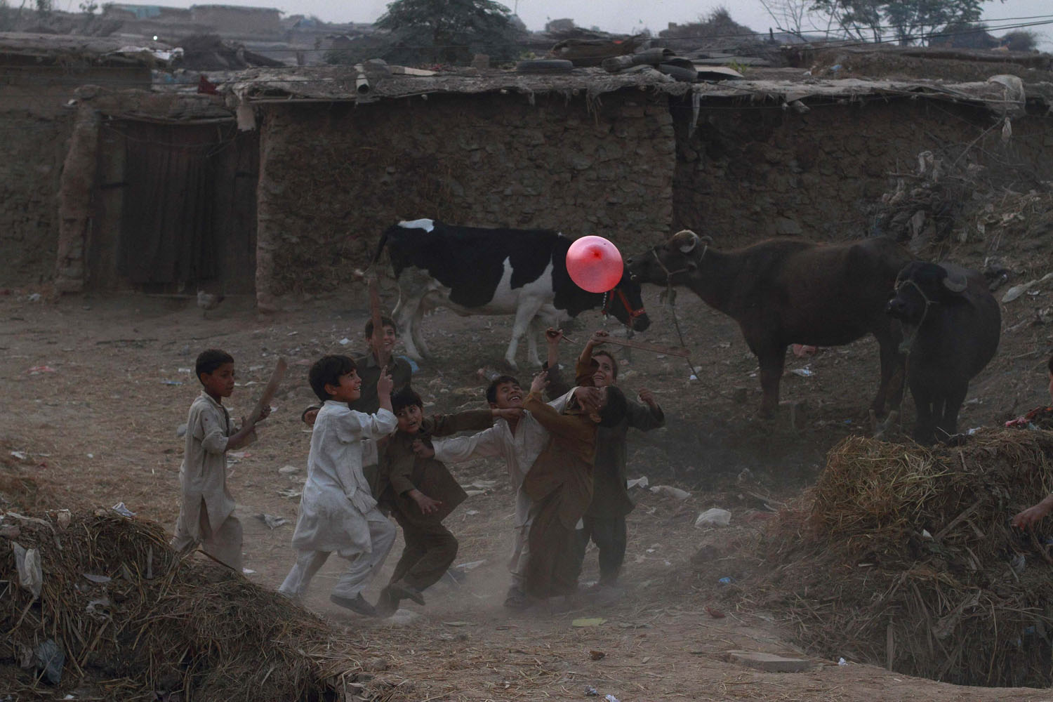 Image: Nov. 2, 2012. Boys play with a balloon at a slum on the outskirts of Islamabad.