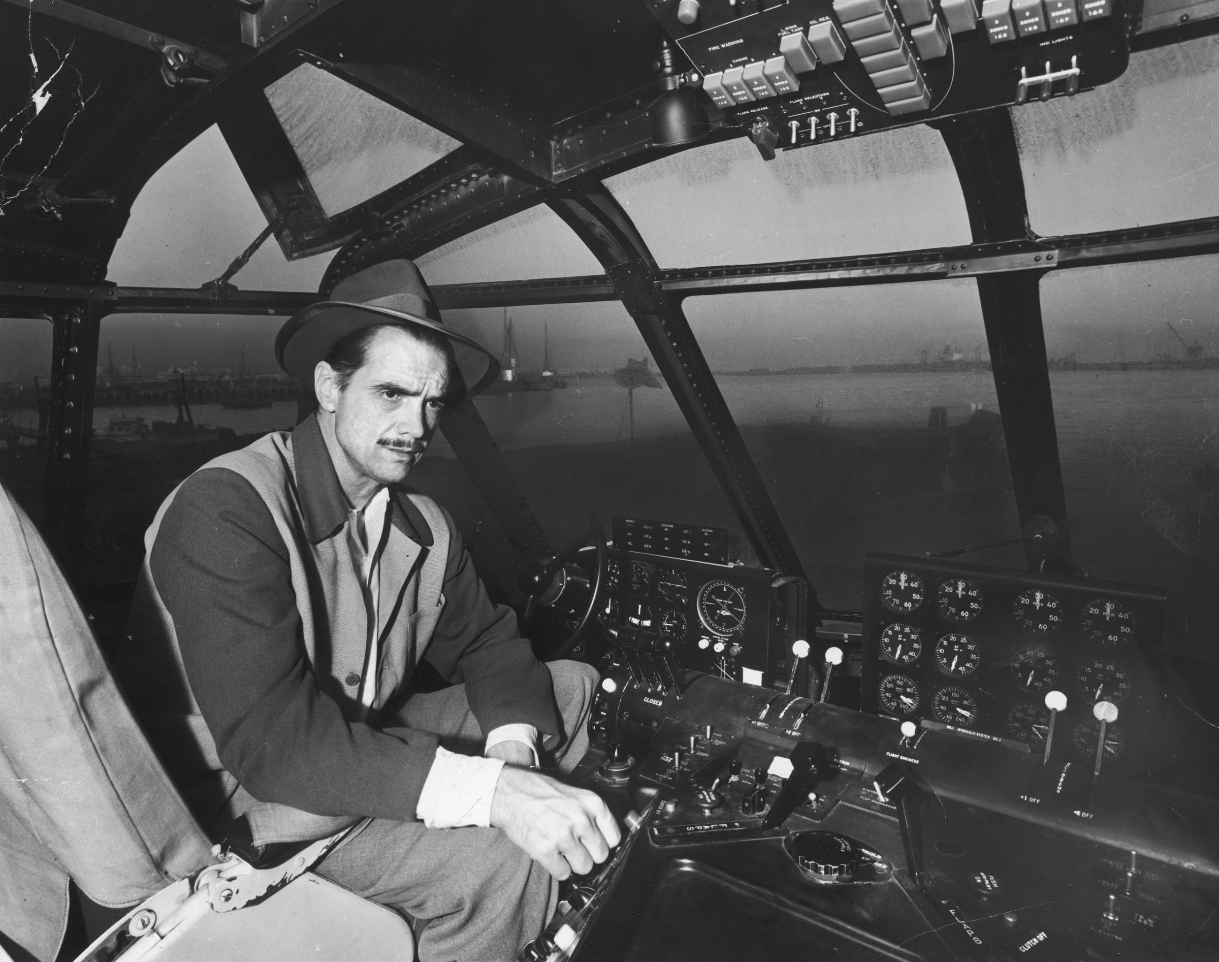 Howard Hughes' at the controls of his H-4 Hercules troop transport plane, the "Spruce Goose," November 1947.