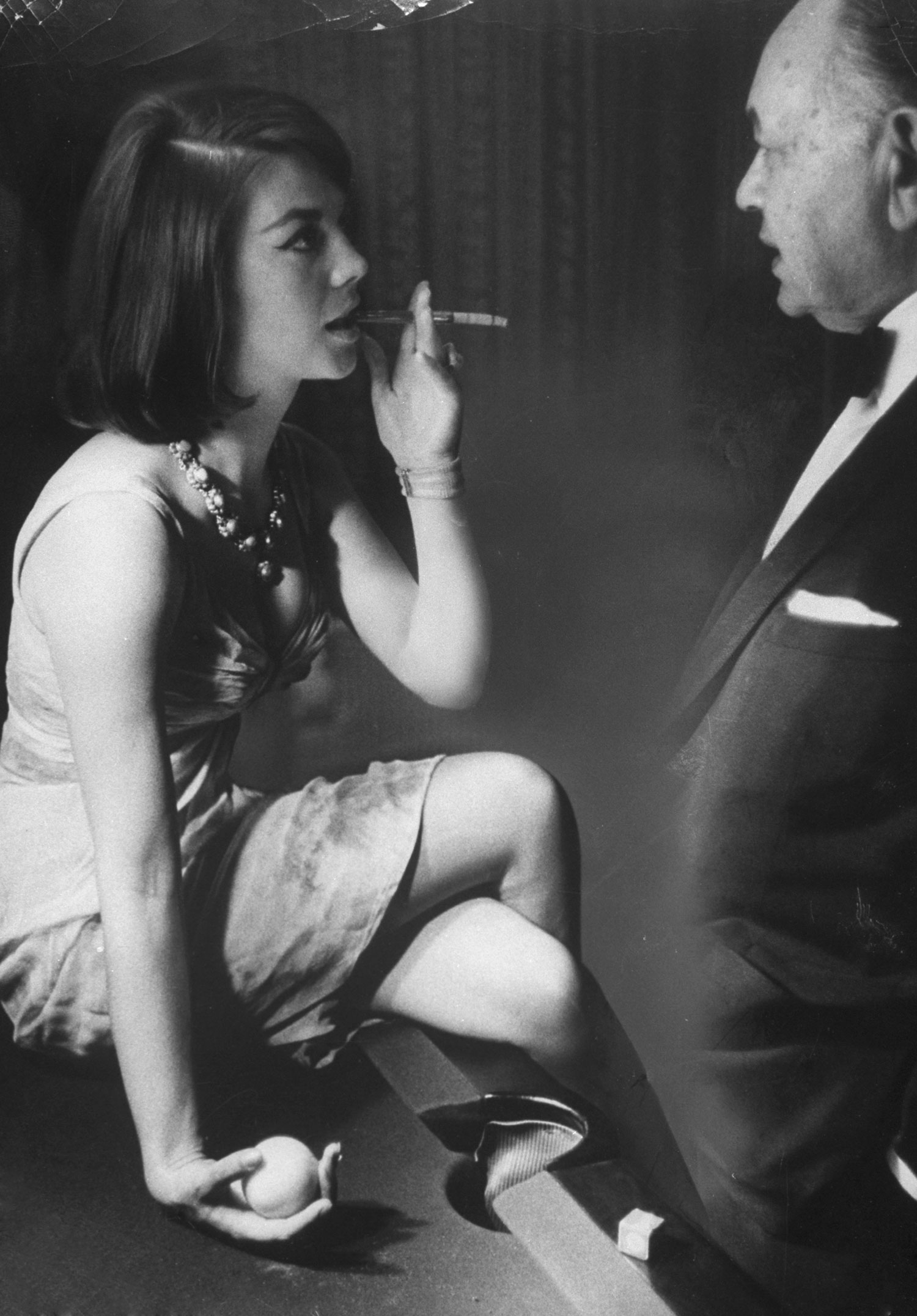 Natalie Wood chats with the movie star Edward G. Robinson, who calls her by her real name, Natasha, in 1963.