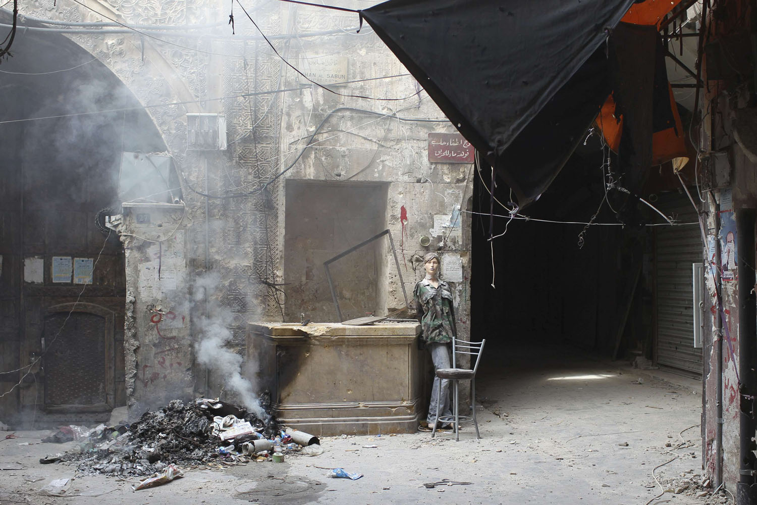 Image: Nov. 2, 2012. A mannequin used by the Free Syrian Army as a decoy is seen in an area where clashes continue with pro-government forces in the Old Town of Aleppo.
