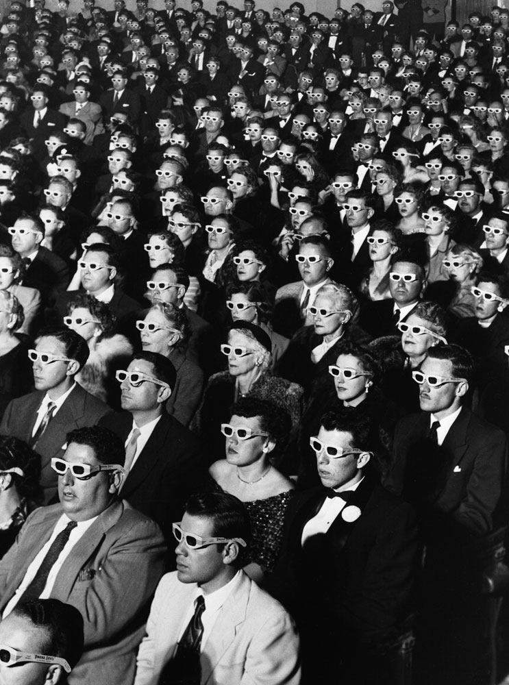 Audience members sport 3-D glasses during the first screening of "Bwana Devil," the first full-length, color 3-D movie, November 26, 1952, at the Paramount Theater in Hollywood.