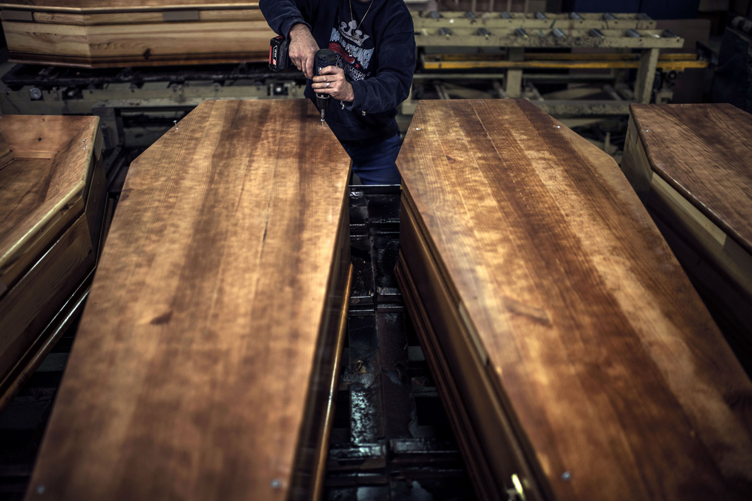 Image: Oct. 29, 2012. An employee of the OGF company works on a wooden coffin on in Reyrieux, France.