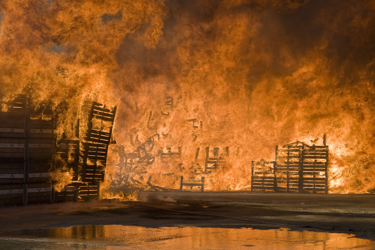Image: Nov. 14, 2012. Fruit bins burn at a packing store in Wolesley, about 120km north of Cape Town.