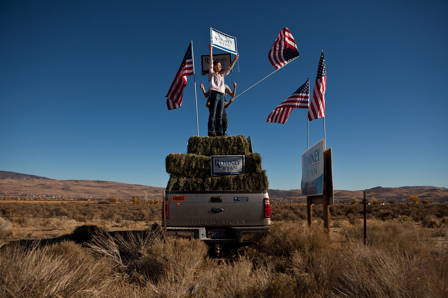 Image: Nov. 6, 2012. Kenady Pettingill, 12, and friends urge drivers to vote for Mitt Romney in Spanish Springs, Nev.