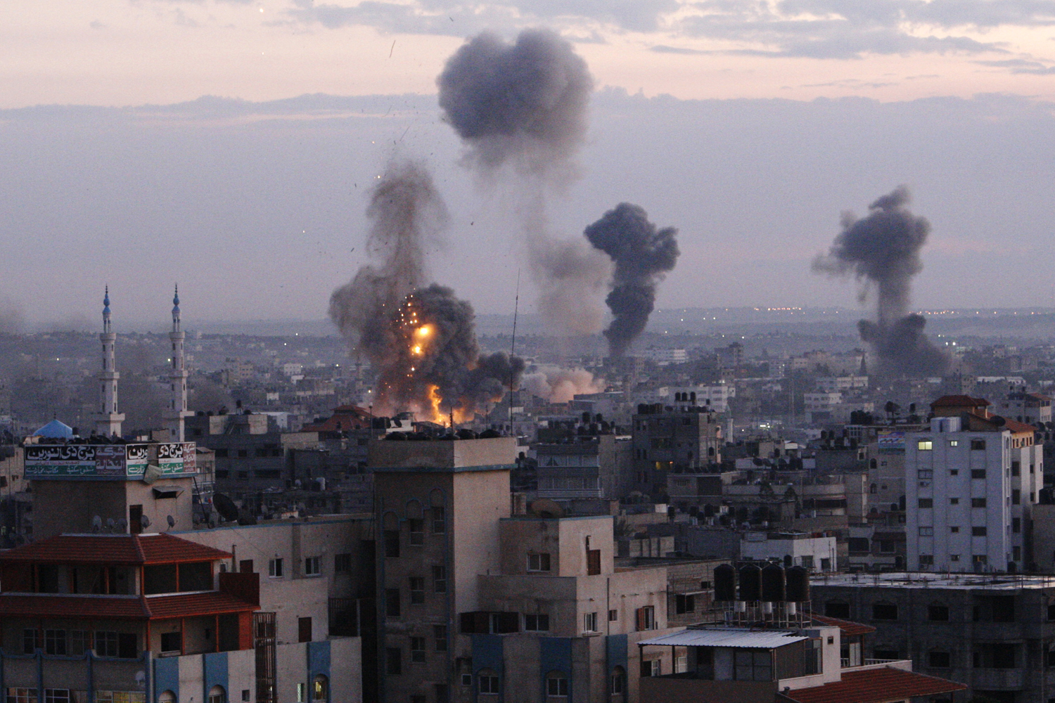 Image: Nov. 14, 2012. Columns of smoke rise following an Israeli air strike in Gaza City.