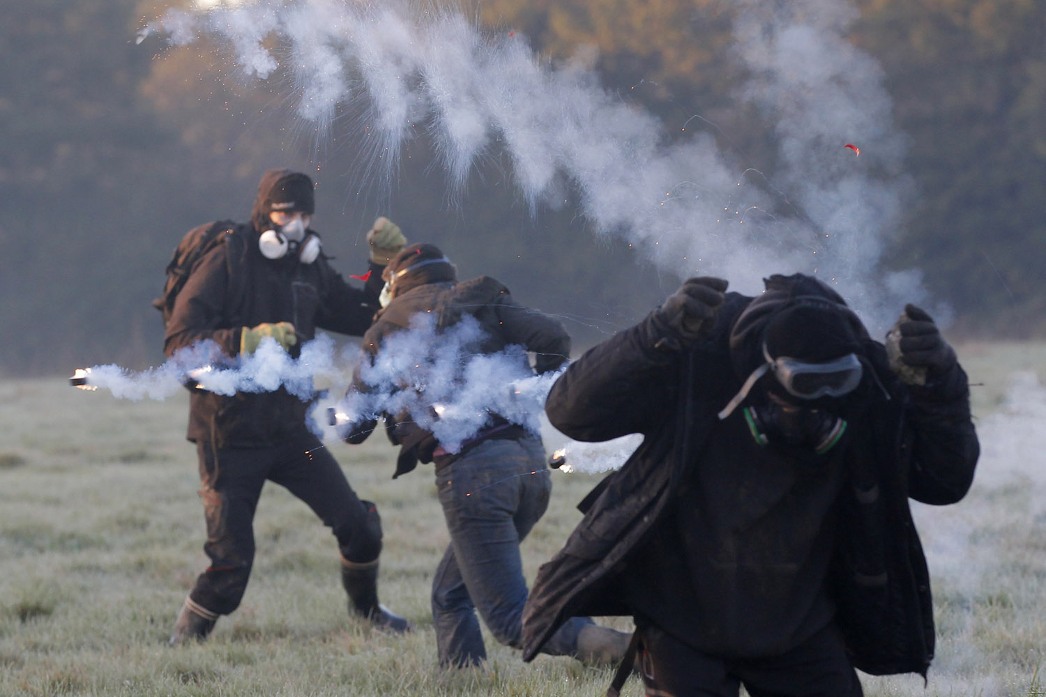 Image: Oct. 30, 2012. Anti-airport protesters clash with French riot gendarmes amid a cloud of teargas during an evacuation operation on the land that will become the new airport in Notre-Dame-des-Landes, western France.