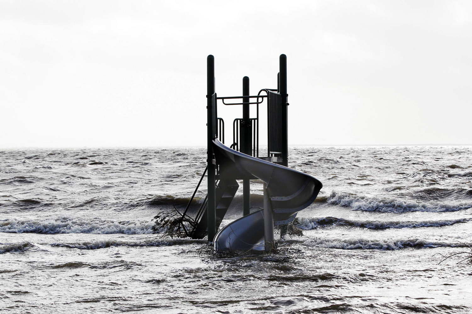 Image: Oct. 30, 2012. A playground stands surrounded by water pushed up by Hurricane Sandy in Bellport, New York.
