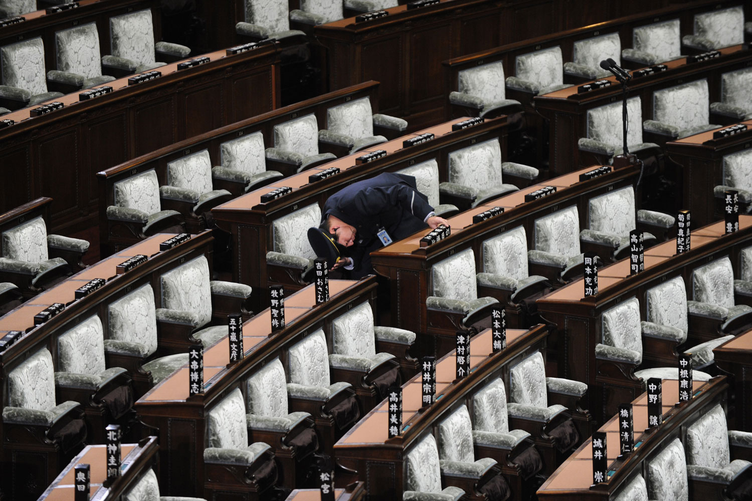 Image: Nov. 16, 2012. A guard checks the vacant plenary session hall of the lower house in Tokyo. Japan's Prime Minister Yoshihiko Noda dissolved the lower house of parliament for an election next month, in a political gamble widely expected to strip his center-left party of power.