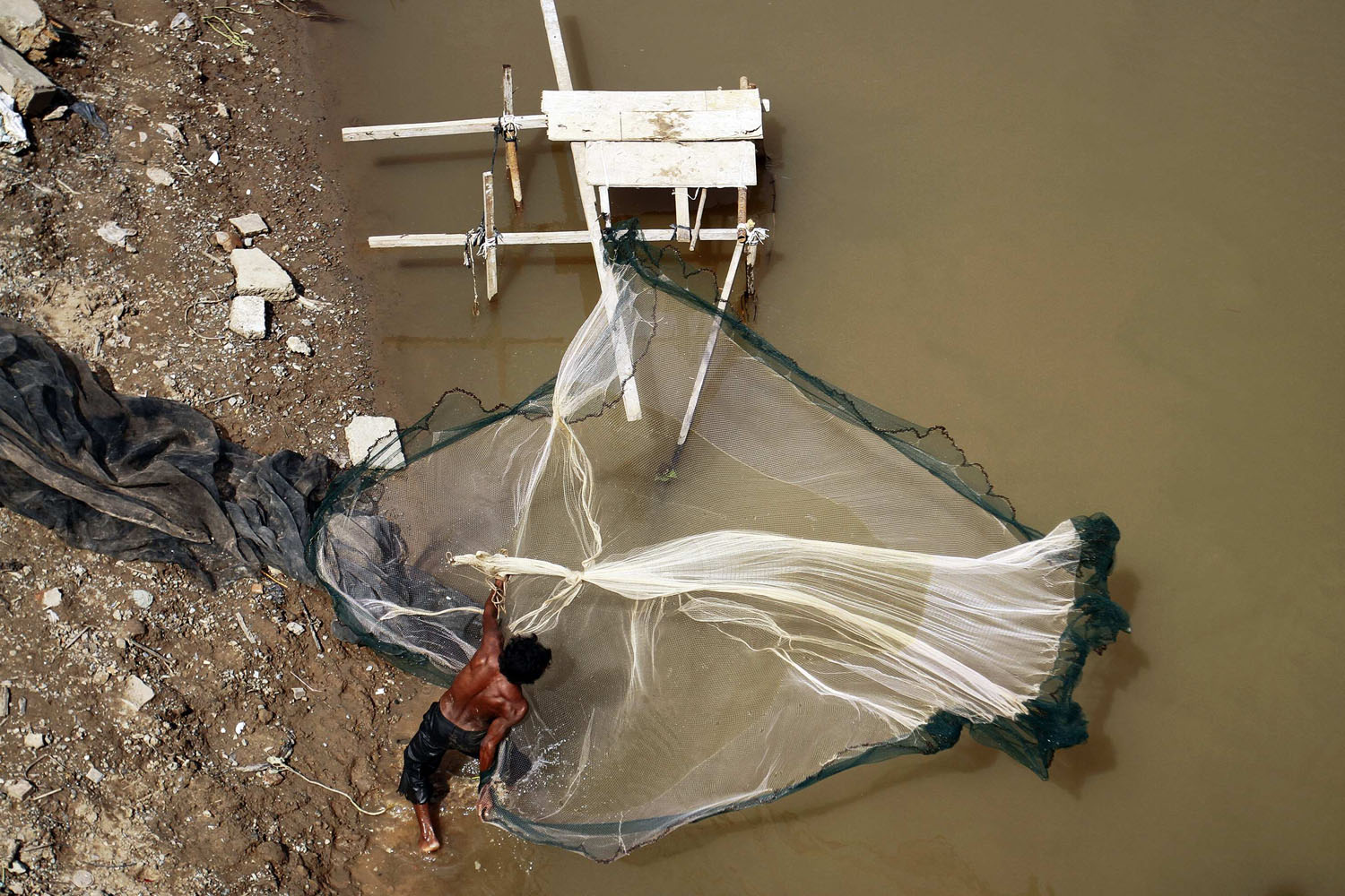 Image: Nov. 7, 2012. A fisherman casts his net in the Mekong river in Phnom Penh.