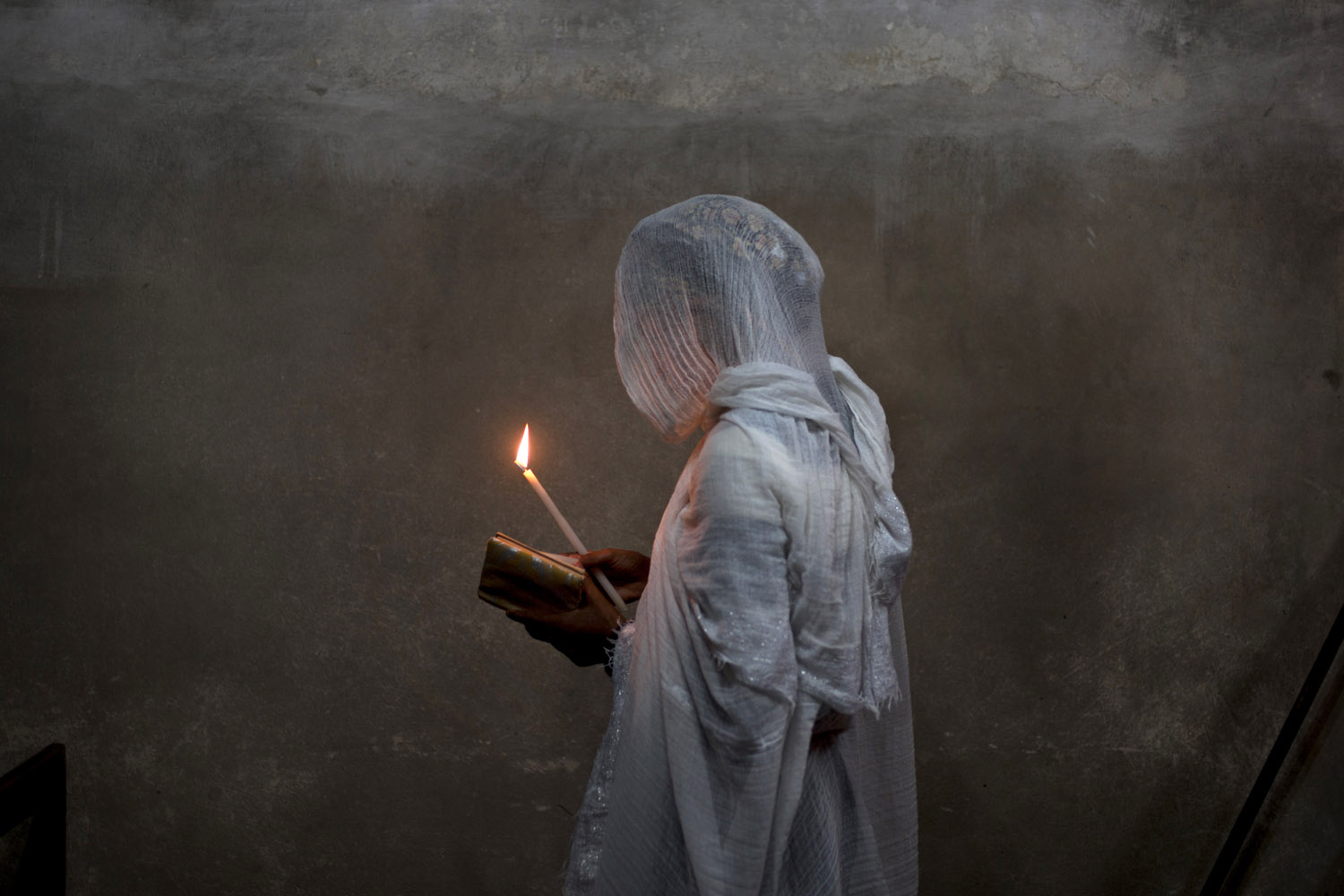 Image: Oct. 31, 2012. An Ethiopian Orthodox Christian woman prays at Deir El Sultan in the Church of the Holy Sepulchre, in Jerusalem's Old City.