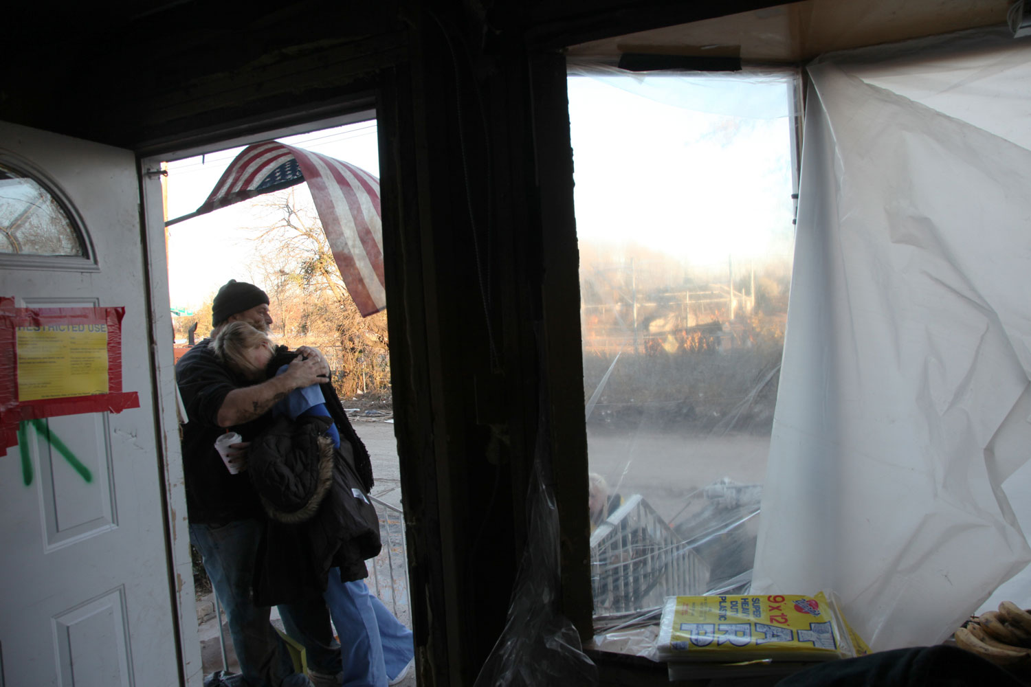 Kevin Oefelein and his daughter Heather embrace outside the doorway of the destroyed first floor of their home on Cedar Grove Avenue in New Dorp.