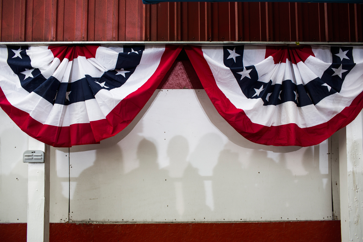 Oct. 24, 2012. Supporters are shadowed on a wall as President Obama attends a campaign rally in Davenport, Iowa.