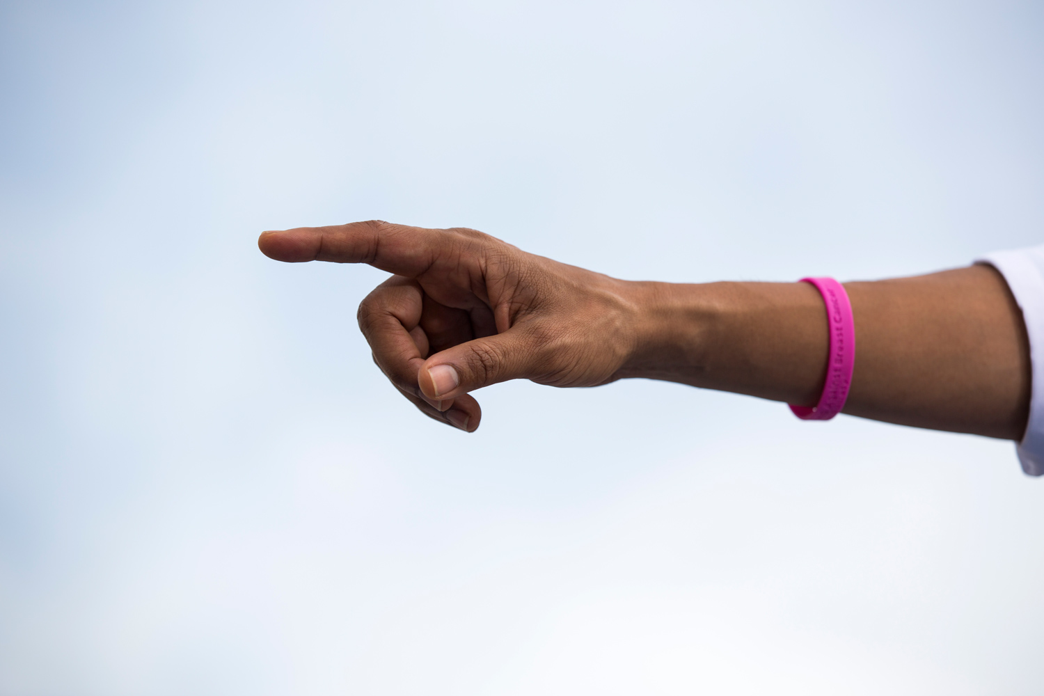Image: Oct. 25, 2012. President Obama attends a campaign rally in Tampa. He is wearing a pink bracelet in support of breast cancer awareness, an important issue with women voters.