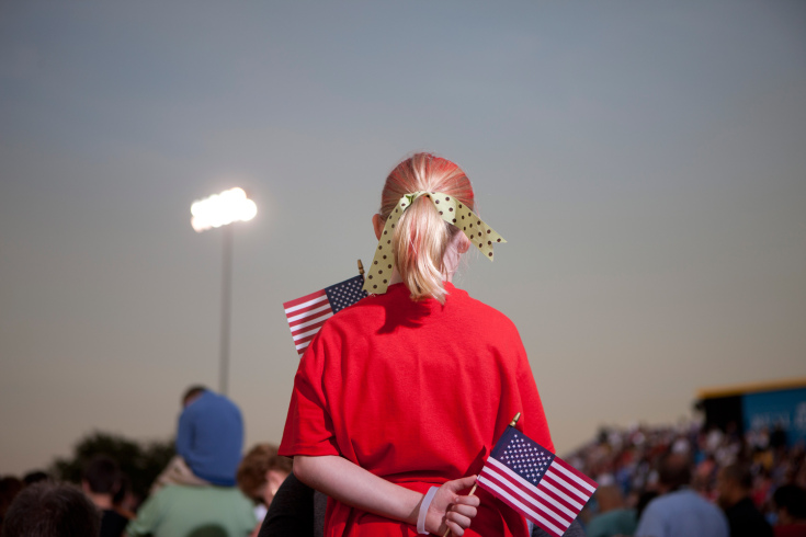 Image: A red-clad Romney supporter clutches two American flags during a rally in Land O’ Lakes, Fla. Oct. 27, 2012.