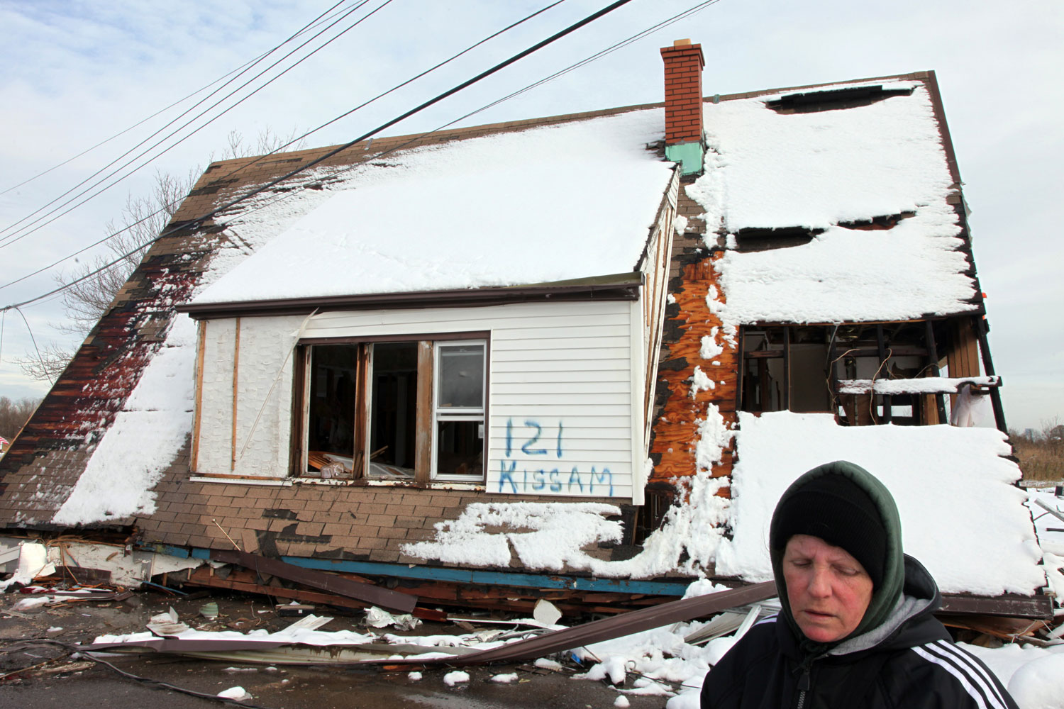 Image: Jane Caravello, who lost her home on Kissam Avenue, spray-painted street numbers onto the remains of her house and her neighbors' homes, to aid insurance adjustors with property damage assessment. Thirteen houses were ripped from their foundations on this block.