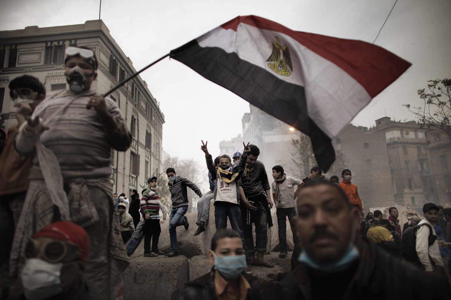 Feb. 6, 2012. Egyptian demonstrators gather next to a concrete barricade during confrontations outside Cairo's security headquarters. Clashes continued in the wake of deadly football violence in Port Said amid calls by activists for civil disobedience.
