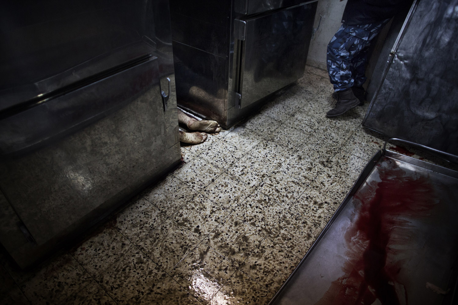 Nov. 20, 2012. The body of an alleged collaborator lies in between fridges inside hospital morgue in Gaza City. Gunmen executed six suspected collaborators and pinned notices to their bodies saying they had been killed by Hamas's armed wing, witnesses told AFP.