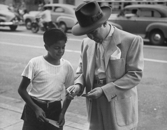 Mickey Cohen signs an autograph for a young fan, Los Angeles, 1949.