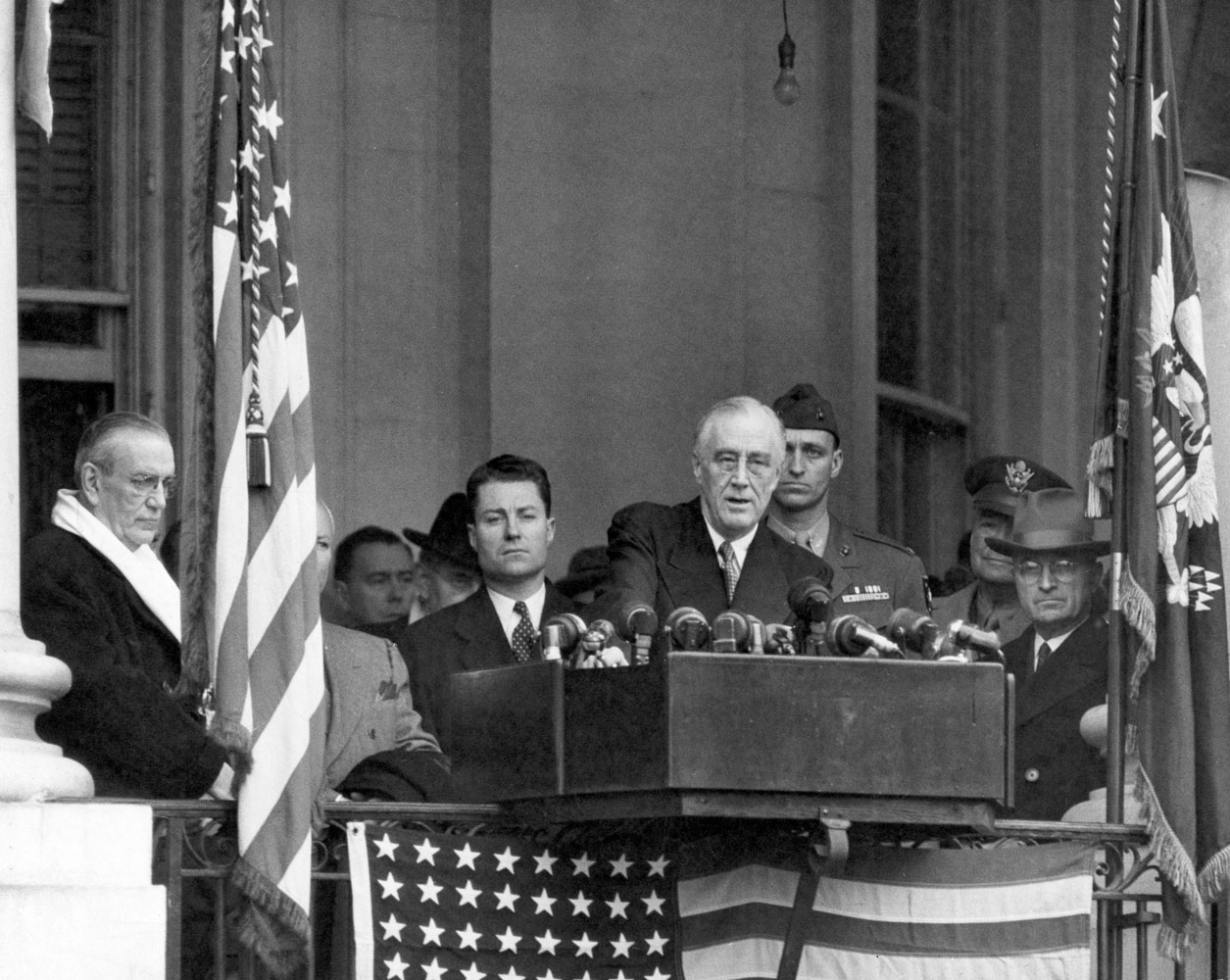 Vice President Harry S. Truman (right) sits in the background as President Franklin D. Roosevelt delivers his fourth inaugural address, 1945.