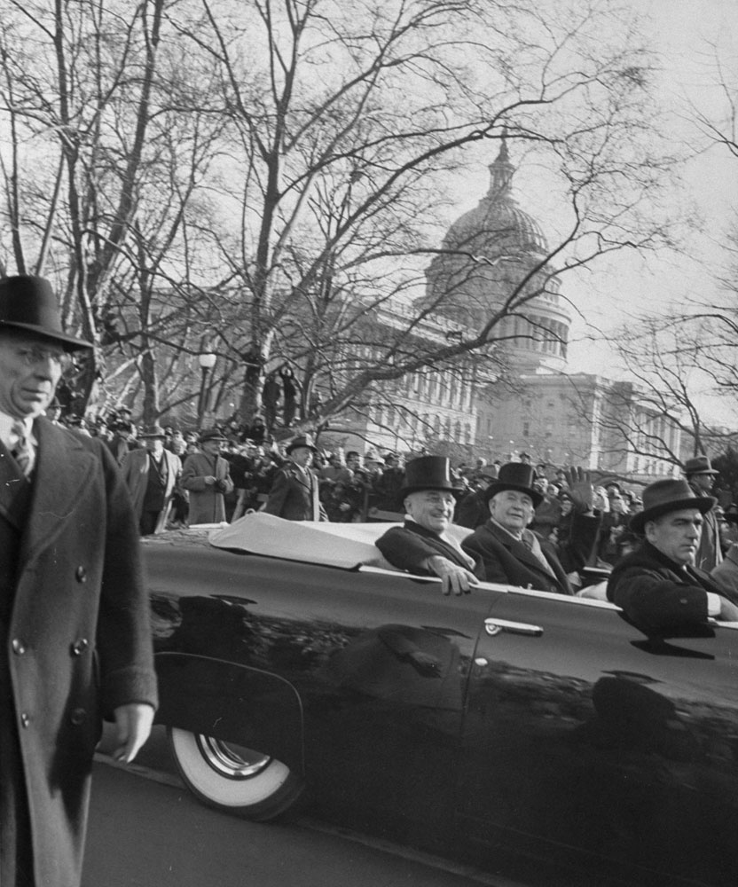 Harry Truman (left) rides with Vice President Alben Barkley during the 1949 inauguration parade.