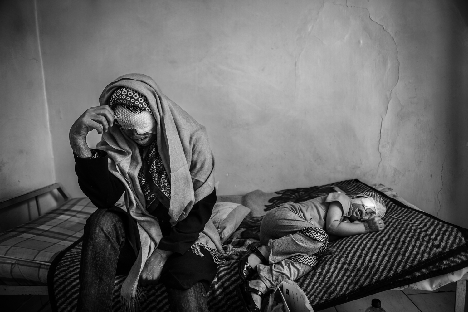 <em>The following photographs were taken between May and December of 2012.</em>Sommayeh and her daughter Rana rest in a hostel in downtown Tehran. The two have shuttled to the Iranian capital for treatment after Sommayeh's husband attacked the family with acid. (Abolfazl Nesaei)
