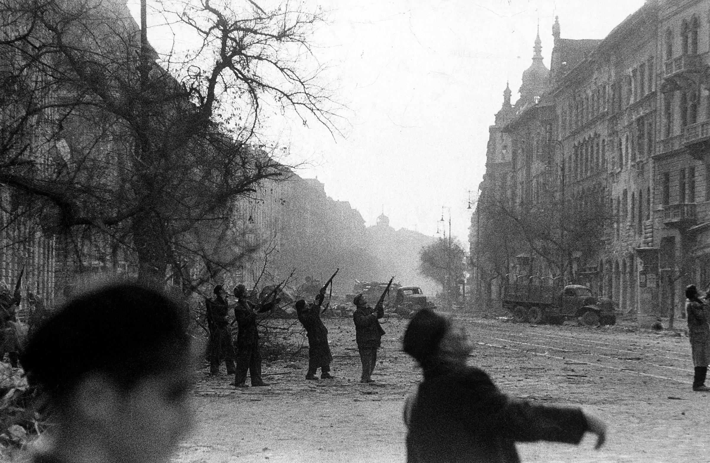 Hungarian resistance fighters fire toward a Russian observation plane shortly before the Soviet annexation of Hungarian territory, 1956.