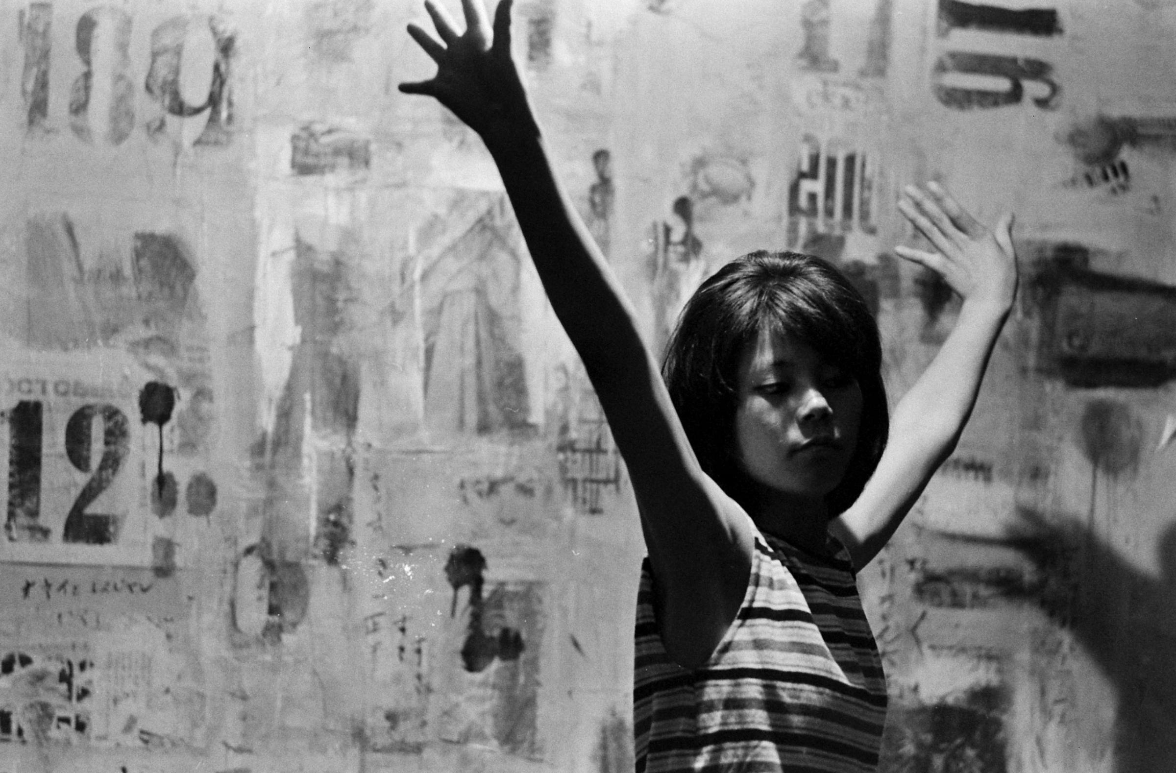 Seventeen-year-old Yoko, with arms outstretched, Japan, 1964.