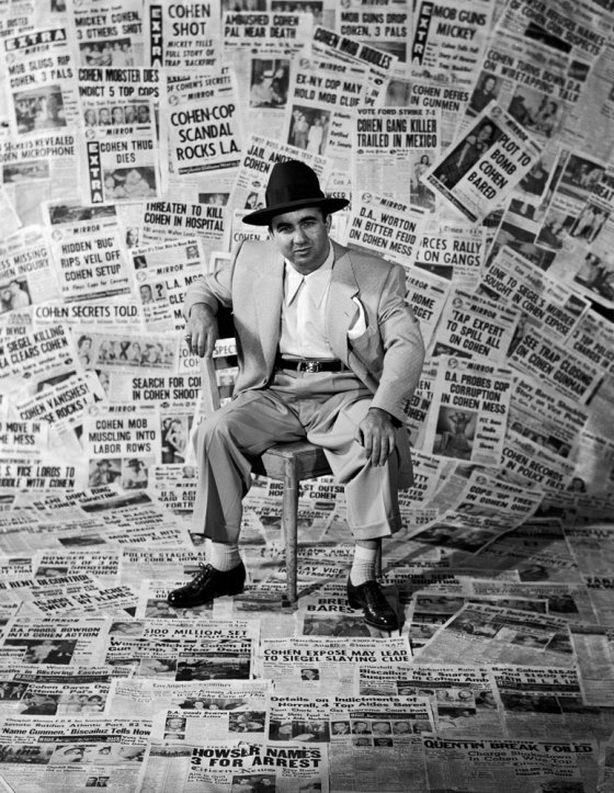 Gangster Mickey Cohen sits amid the front pages of newspapers that helped make him the city's' most infamous citizen, Los Angeles, 1949.