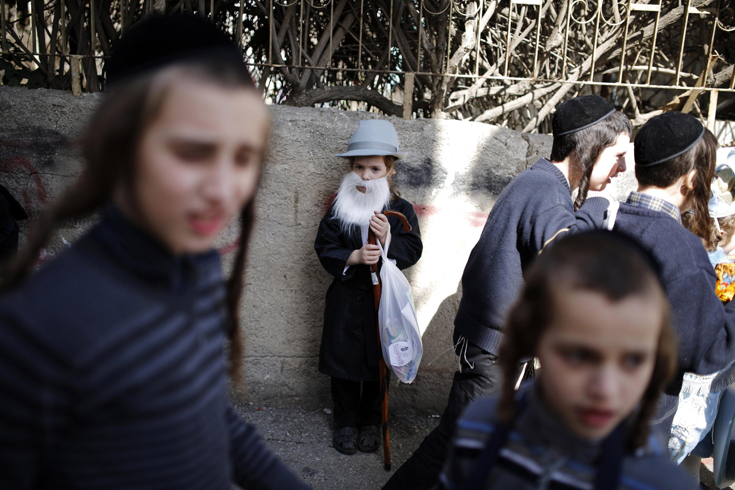 A boy wears a costume ahead of the Jewish holiday of Purim in Jerusalem's Mea Shearim neighbourhood