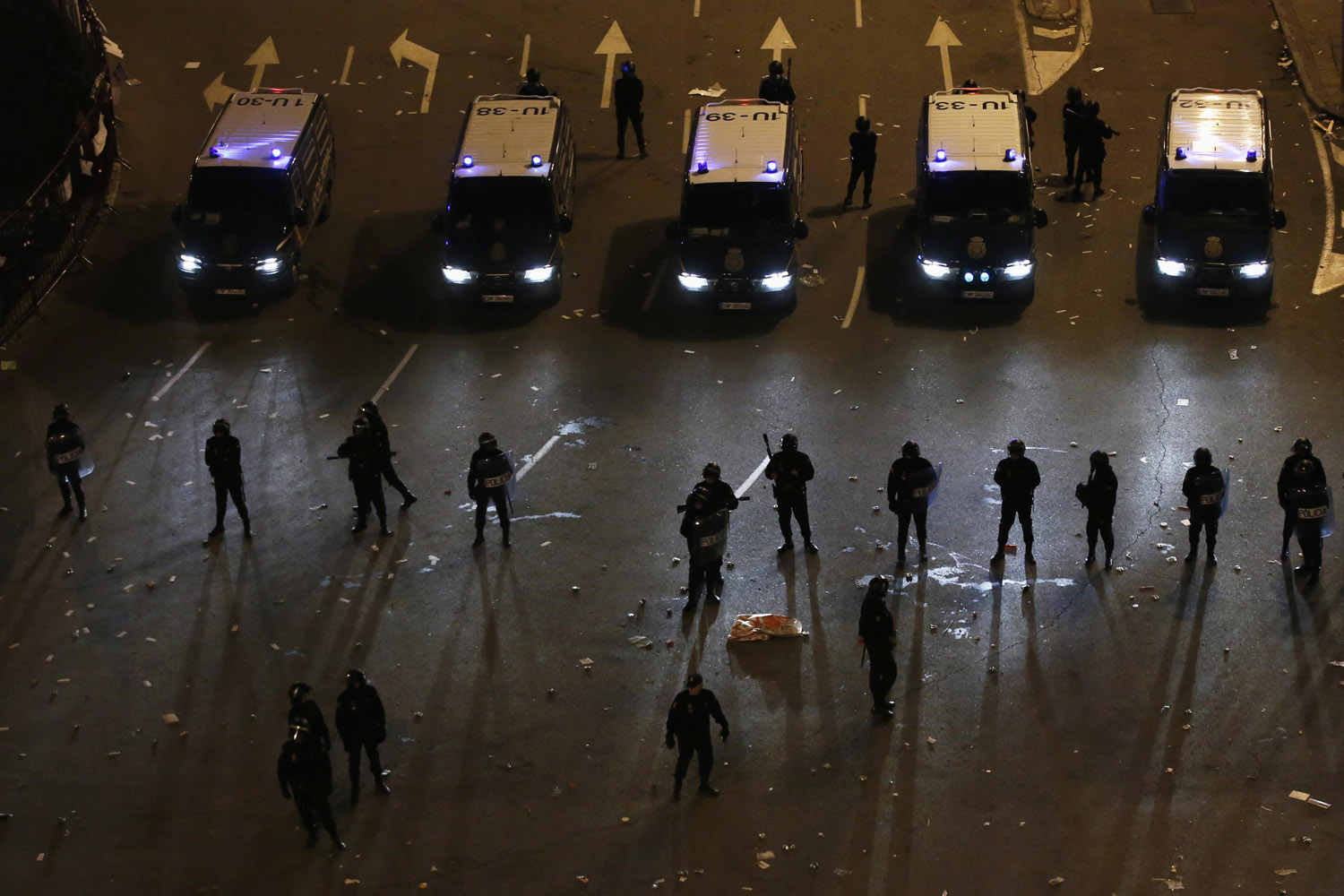 Feb. 23, 2013. Riot police stand in line during a protest against austerity, near the parliament in Madrid, Spain.