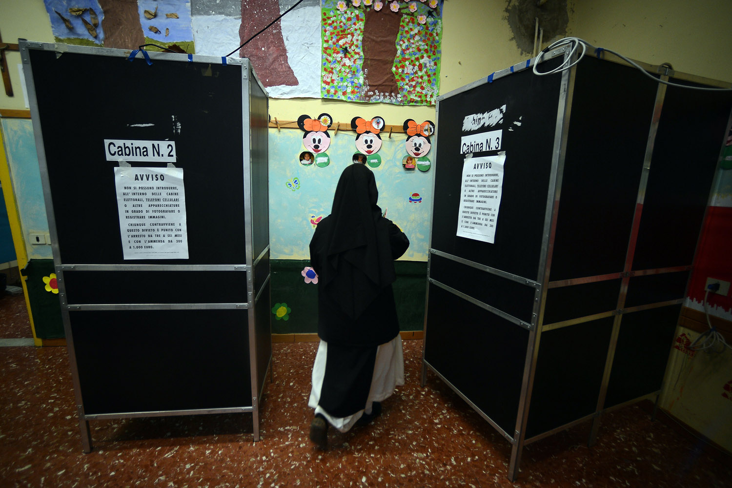 Feb. 24, 2013. A nun gets ready to vote at a polling station in downtown Rome.