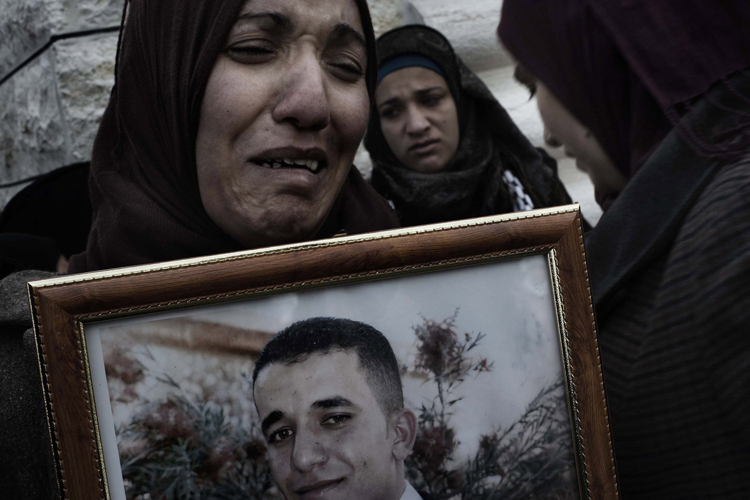 Palestine, Saair: Mourners of Arafat Jaradat (in the picture) are seen as they mourn during his funeral on February 25, 2013. ALESSIO ROMENZI