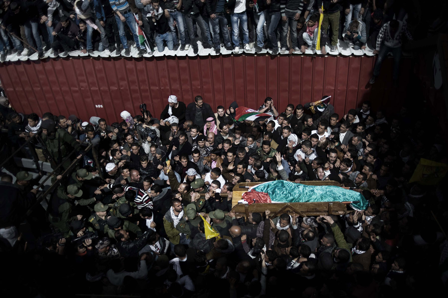 Feb. 25, 2013. Mourners of Arafat Jaradat  are seen as they mourn his coffin in the Palestinian village of Saair.