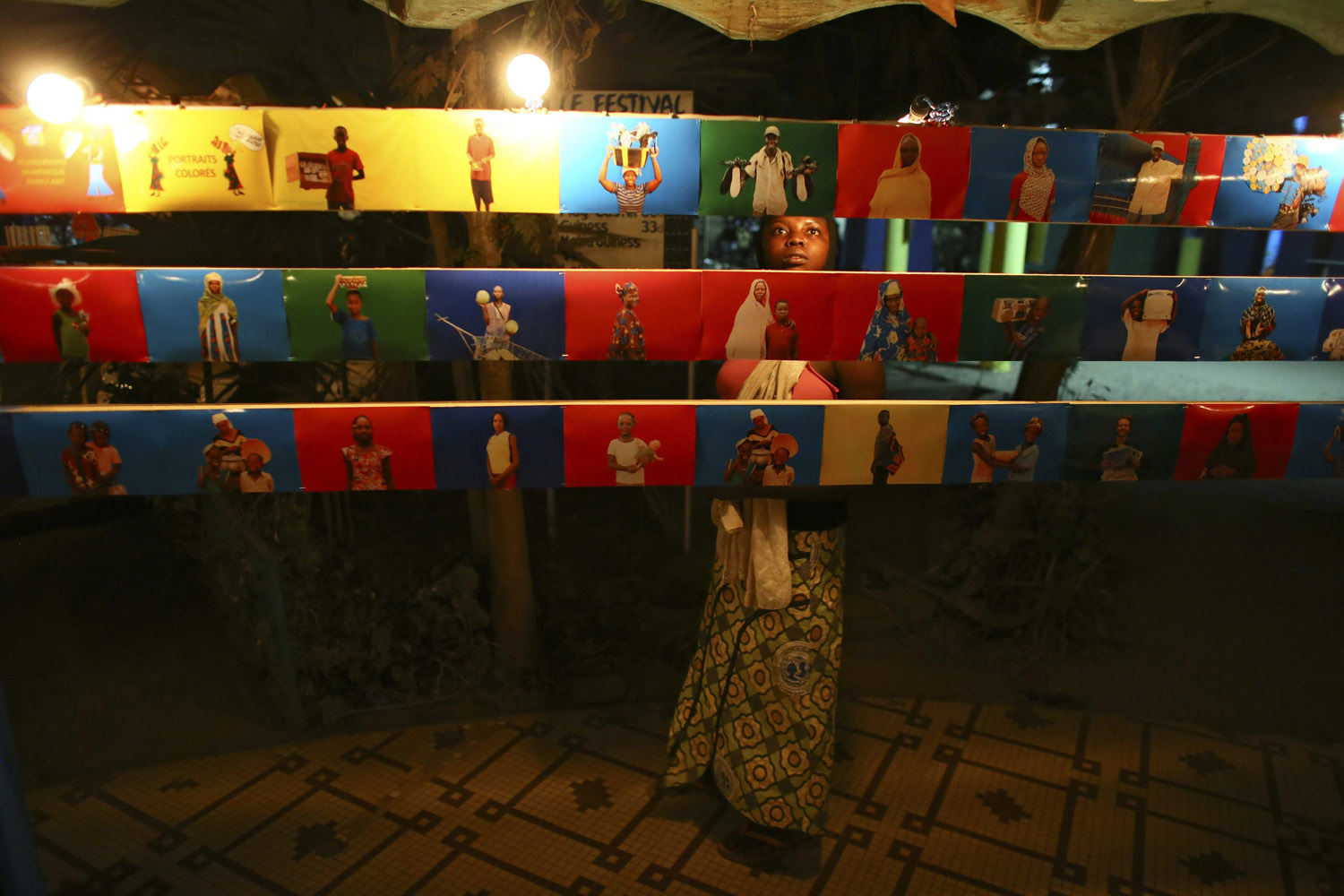 Feb. 24, 2013. A girl from Burkina Faso looks at a photography exhibition during the Panafrican Film and Television Festival in Ouagadougou, Burkina Faso.