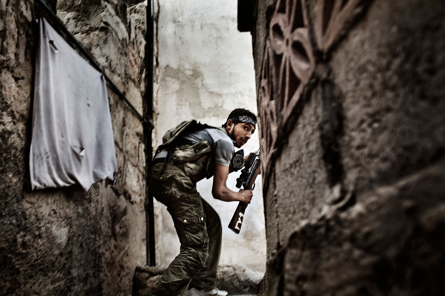 2nd Prize Spot News Stories. Fabio Bucciarelli, Italy. 10 October 2012, Aleppo, Syria. A Free Syrian Army fighter takes up a position during clashes against government forces in the Sulemain Halabi district.